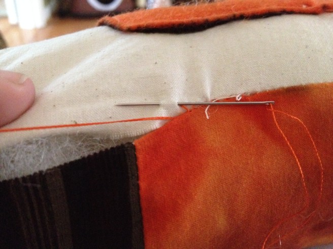 Stitch the hole closed using a ladder stitch OR you can fold edges inward and sew over with a sewing machine. I prefer the finished look hand stitching provides! Trim any straggly threads (like that one one there) after closing up the hole.