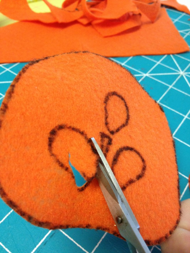 Carefully cut out faces with small scissors.